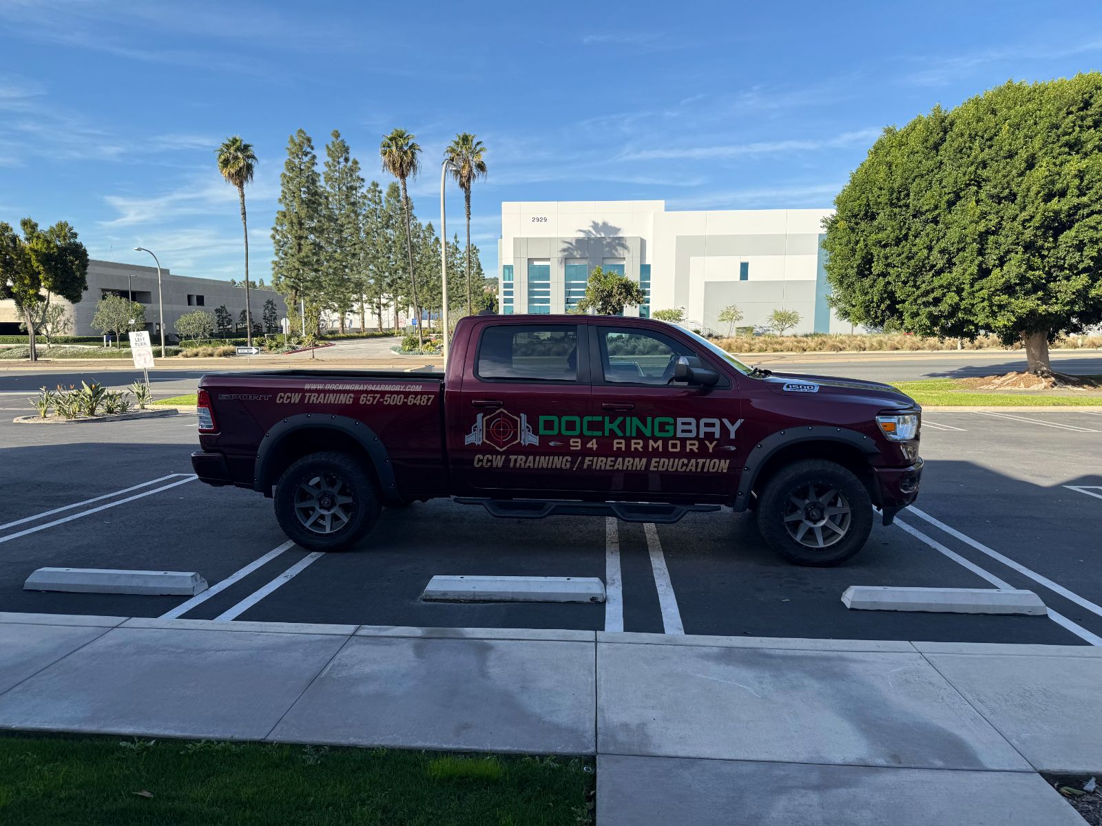 Maroon Ram pickup with cast vinyl logo and lettering across the cab and bed