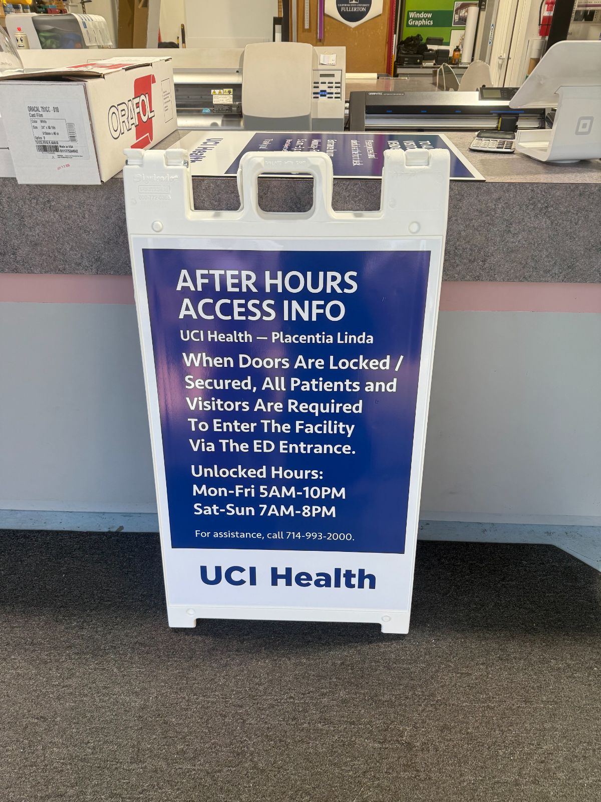 White A-frame sidewalk sign with a printed UCI Health panel insert