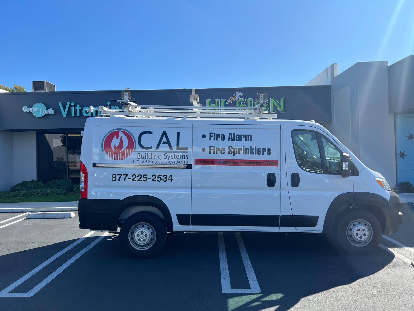 White CAL Building Systems cargo van with cut vinyl fire-flame logo and lettering